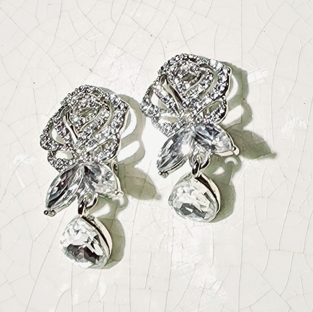 Modern brilliant rhinestone encrusted filigree rose clip on earrings, formal